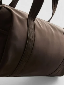 Bolso cilíndrico con bolsillo y cremallera