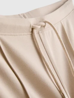 Joggers acampanados con alforzas y algodón