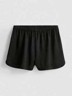 Pantalones cortos deportivos de satén holgados