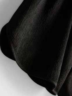 Pantalones cortos deportivos de satén holgados