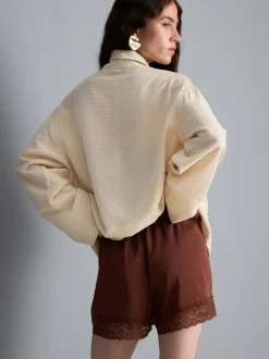 Pantalones cortos de satén con ribete de encaje