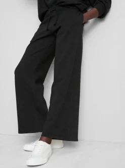 Pantalones de chándal anchos con aplicación