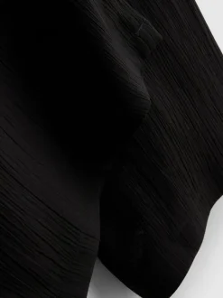 Pantalones de pernera ancha con efecto arrugado