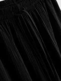 Pantalones de pernera ancha con efecto arrugado