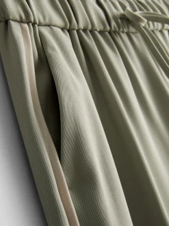 Pantalones de pernera ancha con rayas laterales