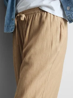 Pantalones de pernera ancha con efecto arrugado