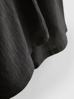 Pantalones de pernera ancha con efecto arrugado