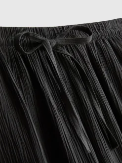Pantalones de pernera ancha con efecto arrugado
