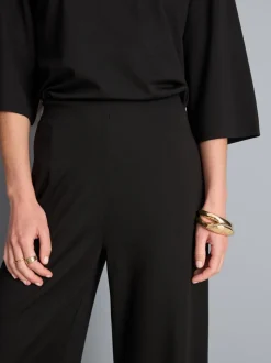 Pantalones de punto plisados de pernera ancha