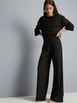 Pantalones de punto plisados de pernera ancha