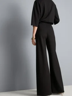 Pantalones de punto plisados de pernera ancha
