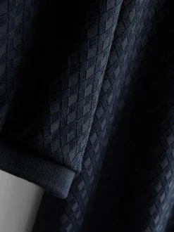 Polo con cremallera y textura de The Edit