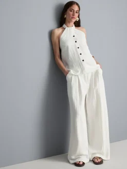 Top con cuello halter, botones y textura