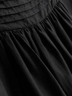 Vestido midi con bajo de corte pañuelo